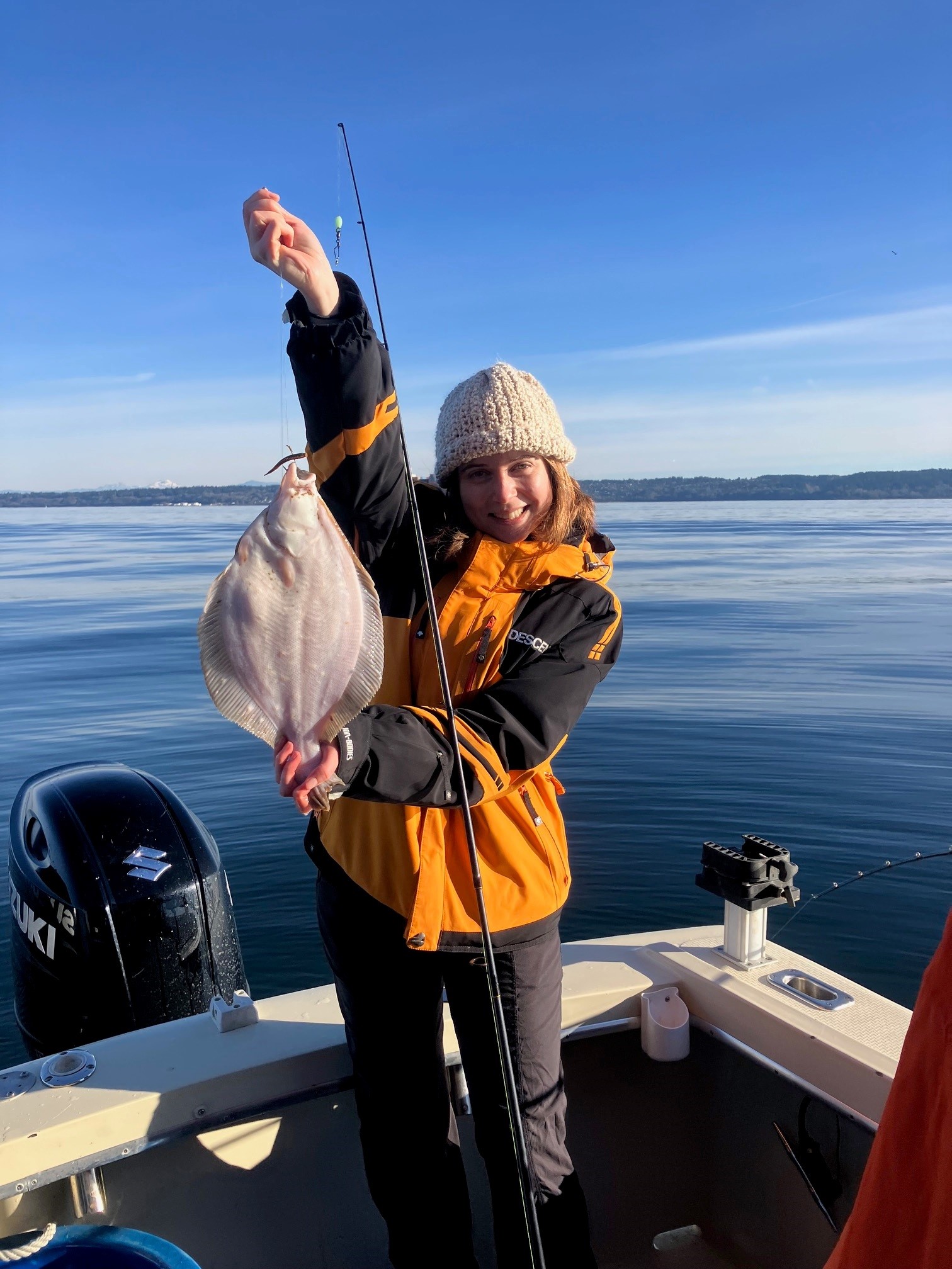 Angler holding a Puget Sound flounder caught on an All Star Fishing Charters trip.